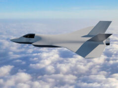 Half of new UK fighter jet demonstrator now assembled Stealth fighter jet with angular wings flying above a sea of clouds in a clear blue sky, horizon visible.