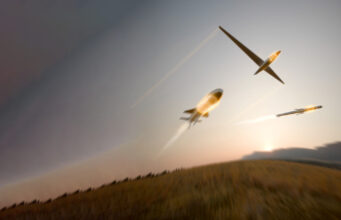 BAE unveils BlackThorn warhead for drones and missiles Three gliders soaring in a dusky sky with light-trail contrails behind them.