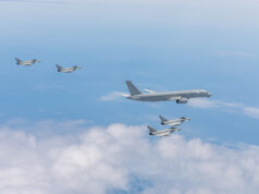 Excalibur flying testbed enters new GCAP trials phase Six gray military fighter jets flying in formation over a blue sky with white clouds.