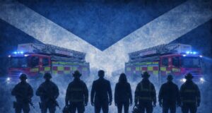 Silhouetted firefighters stand in front of two ladder fire engines with blue emergency lights, against a large Scottish flag backdrop.