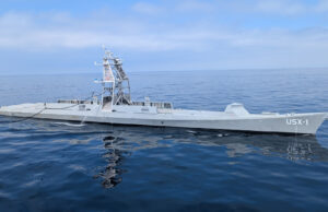 Maritime autonomy: the race is on for the Navy of the future Large gray naval vessel with a tall lattice-like superstructure sailing on calm blue ocean.”