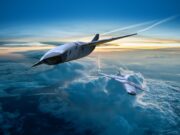 Britain’s new drone fighter may be carrier capable Two sleek, futuristic aircraft in formation above a cloud layer at sunset.