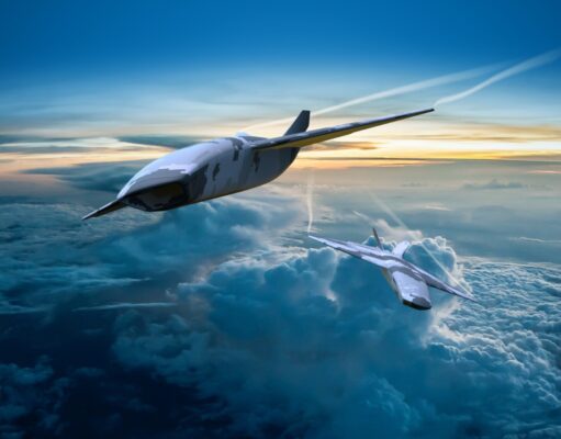 Britain’s new drone fighter may be carrier capable Two sleek, futuristic aircraft in formation above a cloud layer at sunset.
