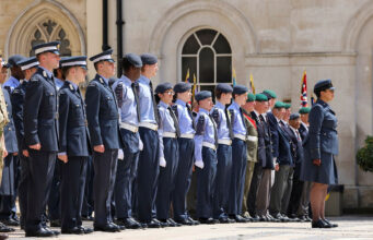 Cadet expansion target slips five years to 2035 Line of uniformed military personnel standing at attention during a ceremonial parade outside a historic building.