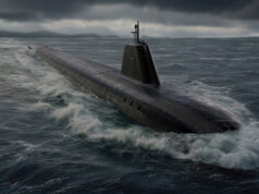Dark submarine surfacing and cutting through rough sea under a stormy, low-hanging sky, with a raised sail and antennas visible atop the hull.