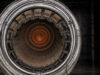 Close-up of a metallic turbine engine, concentric rings framing an orange-hot center, viewed head-on for an industrial feel