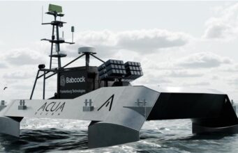 Babcock signs deal to explore armed drone boats Autonomous research vessel at sea with a tall mast and sensor arrays on deck.