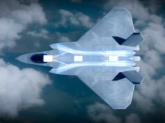 Engine for Britain’s next fighter jet moves toward testing Top-down view of a futuristic aircraft slicing through blue sky and clouds, glowing propulsion visible along its belly