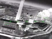 Ukrainian strikes moving to isolate Crimea, official says Night-vision aerial view of a rooftop building with smoke plume on the right and green HUD markers labeled 'FIRE POINT'.
