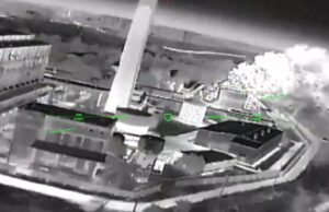 Putin adviser raises attacks on British drone factories Night-vision aerial view of a rooftop building with smoke plume on the right and green HUD markers labeled 'FIRE POINT'.