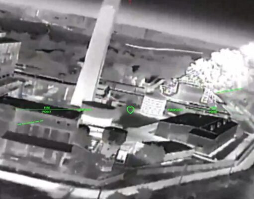 Ukrainian strikes moving to isolate Crimea, official says Night-vision aerial view of a rooftop building with smoke plume on the right and green HUD markers labeled 'FIRE POINT'.