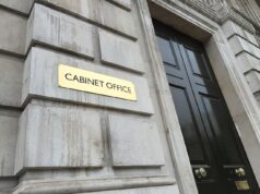 Social value weighting doubled in government contracts Gold plaque reading 'CABINET OFFICE' mounted on a weathered stone wall beside a tall black door with brass handles.