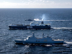 Allied forces move military power across the Baltic Two large ships sail on open sea, a blue DFDS ferry behind a gray military vessel labeled F342.