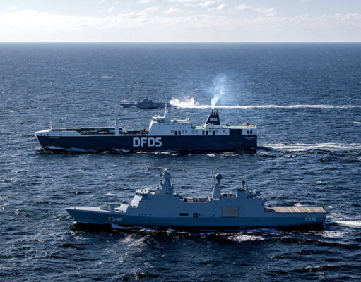 Allied forces move military power across the Baltic Two large ships sail on open sea, a blue DFDS ferry behind a gray military vessel labeled F342.