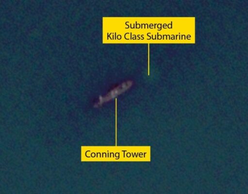 Submerged Kilo-class submarine with its conning tower visible underwater labeled in yellow boxes and lines to the parts.