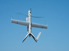 Canada gets first Airbus Flexrotor drones in Voyageur deal Unmanned aerial vehicle (drone) with a fixed wing and helicopter-style rotor against a blue sky in flight.