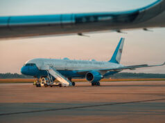 Trump flew into RAF base as Air Force One acted as decoy United States government aircraft parked on the tarmac with mobile stairs and a blue nose, during sunset.