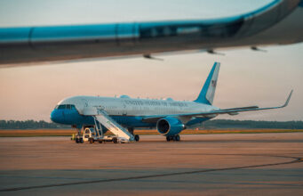 Trump flew into RAF base as Air Force One acted as decoy United States government aircraft parked on the tarmac with mobile stairs and a blue nose, during sunset.