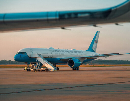 Trump flew into RAF base as Air Force One acted as decoy United States government aircraft parked on the tarmac with mobile stairs and a blue nose, during sunset.