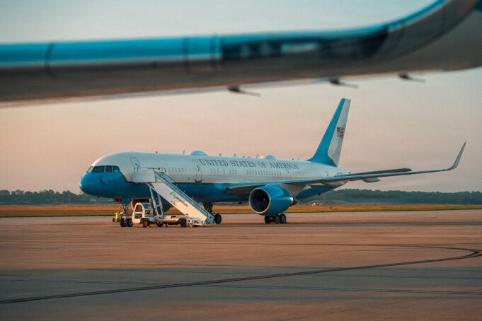 Trump flew into RAF base as Air Force One acted as decoy United States government aircraft parked on the tarmac with mobile stairs and a blue nose, during sunset.