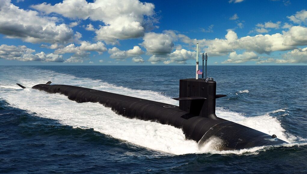 A dark submarine gliding at the ocean surface, creating a white wake with a blue sky and clouds above, a small American flag on the conning tower.