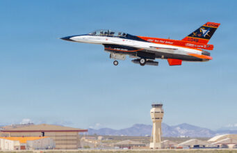 X-62 test jet uses AI to intercept airborne target USAF Test Pilot School jet trainer with two crew taking off from an airbase; control tower in the background.