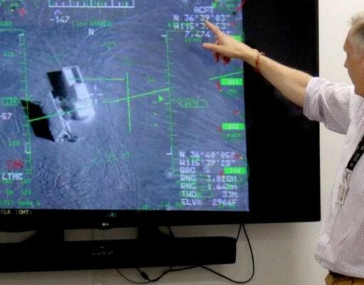 British firm Inzpire to train Ukrainian pilots in air tactics Person in a light shirt points at a large screen displaying a flight navigation/avionics interface with green markers and data.