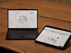 The British firm sizing military powertrains in hours Laptop shows a circular data dashboard while a tablet displays a map dashboard on a wooden table.
