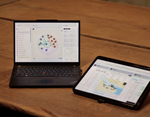 The British firm sizing military powertrains in hours Laptop shows a circular data dashboard while a tablet displays a map dashboard on a wooden table.