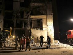 Targeting of Ukraine politicians among Russian options Nighttime scene of a collapsed building with rescue workers and a fire truck inspecting the rubble.