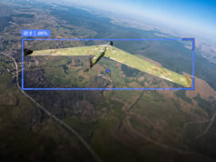 Ukraine says 260,000 Russian drones neutralised this year Camouflaged military aircraft in flight over farmland, with a blue HUD box showing ID 2 and 96%.